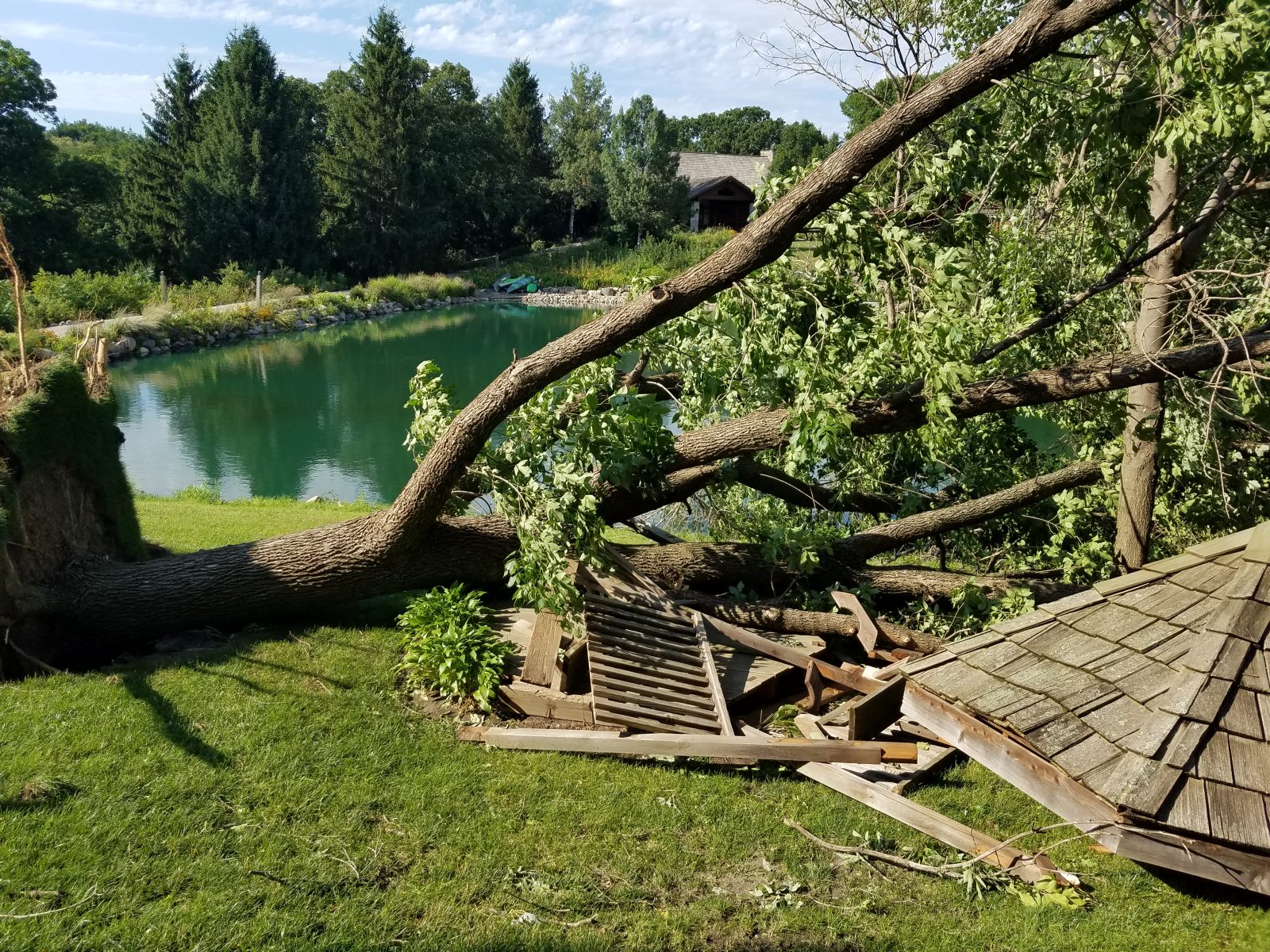 Derecho damage in Ames, Iowa, after the 10 August 2020 derecho: a collapsed outbuilding with debris scattered across a yard