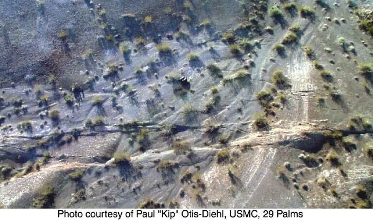 Aerial view of the surface rupture from the 16 October 1999 Hector Mine earthquake in the Mojave Desert, with people standing beside the fault trace for scale